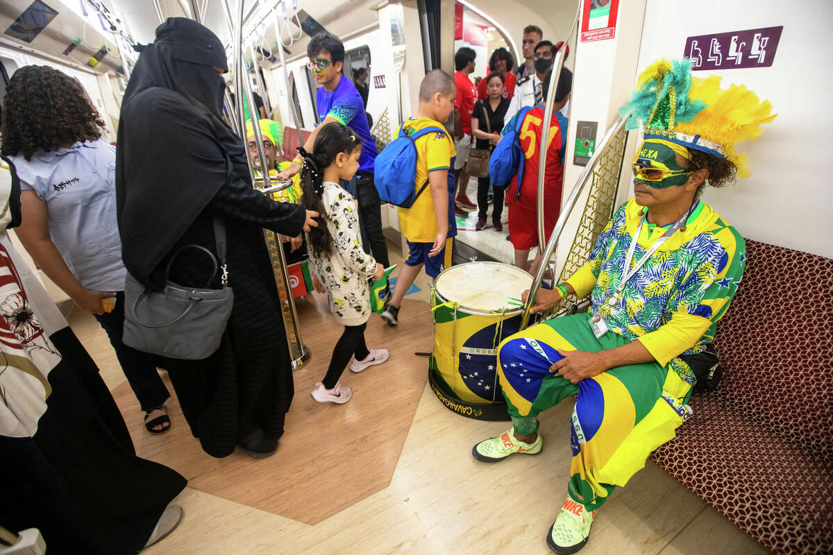 Wallace Leite, right, rides the Doha Metro to Stadium 974 before the Brazil-Switzerland World Cup game in Doha, Qatar, on Nov. 28.