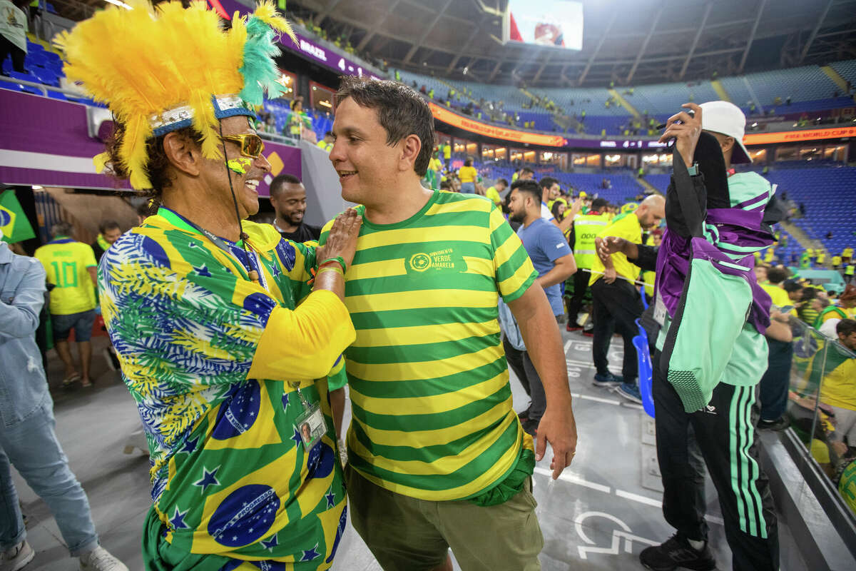 Brazilian Wallace Leite (left) talks with another fan after the Brazil and South Korea World Cup game at Stadium 974 in Doha, Qatar on December 5, 2022.