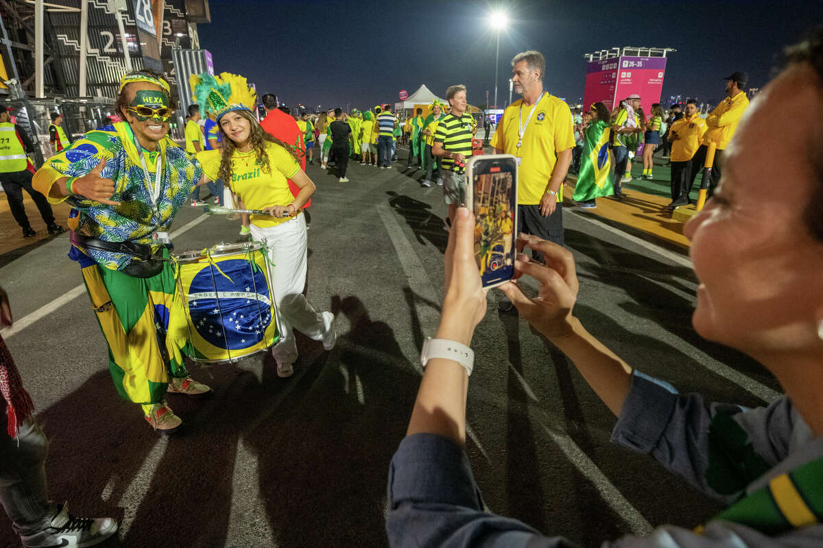 Wallace Leite, left, poses with a Brazil fan after the Brazil-Switzerland World Cup game at Stadium 974 in Doha, Qatar, on Nov. 28.