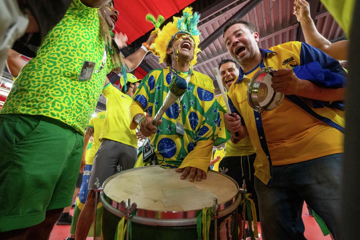 Brazilian Wallace Leite (center) plays his drum while leading some fans in a chant after the Brazil and South Korea World Cup game at Stadium 974 in Doha, Qatar on December 5, 2022.