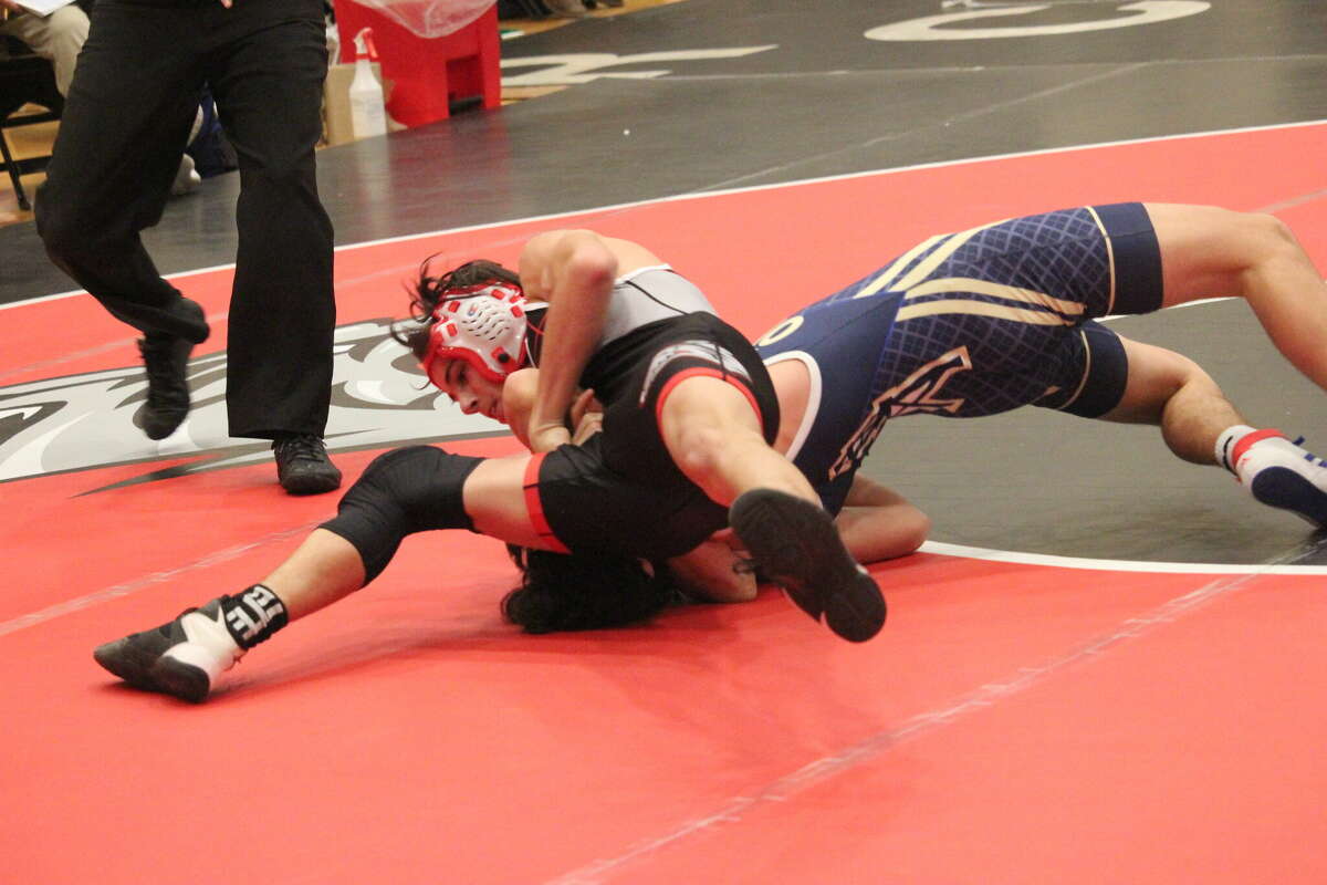 Reed City's Barron Bowman works on pinning Mount Pleasant's Brandon Florian at the 112-pound match on Wednesday.