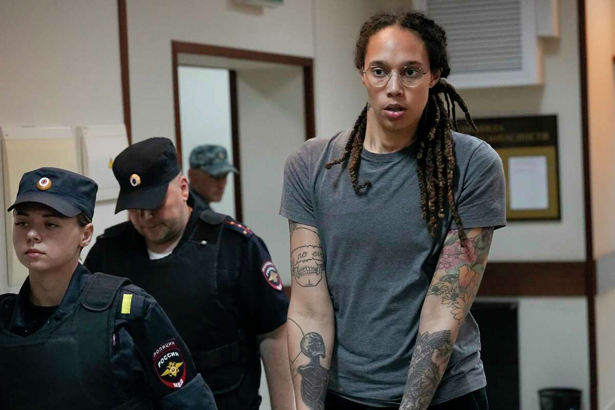 FILE - WNBA star and two-time Olympic gold medalist Brittney Griner is escorted from a courtroom after a hearing in Khimki just outside Moscow, on Aug. 4, 2022. Russia has freed WNBA star Brittney Griner on Thursday in a dramatic high-level prisoner exchange, with the U.S. releasing notorious Russian arms dealer Viktor Bout.