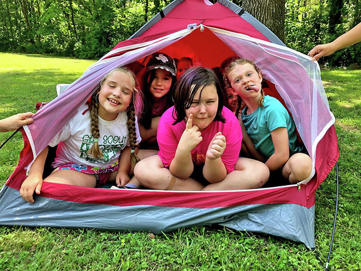 A group of Girl Scouts learning tent put-up and safety skills at Collinsville Service Unit Day Camp.