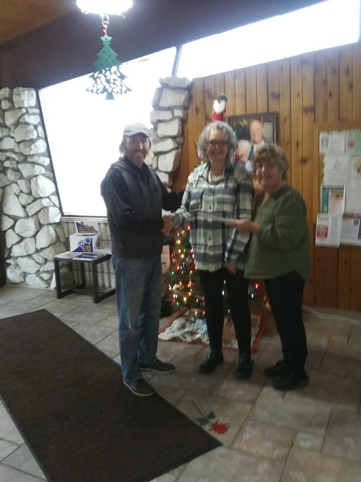  Rick Tetsworth, Filer Credit Union Board of Directors, presents $500 to the Wagoner Center. Shown accepting the check are Jeanne Barber and Netters Cooper. 