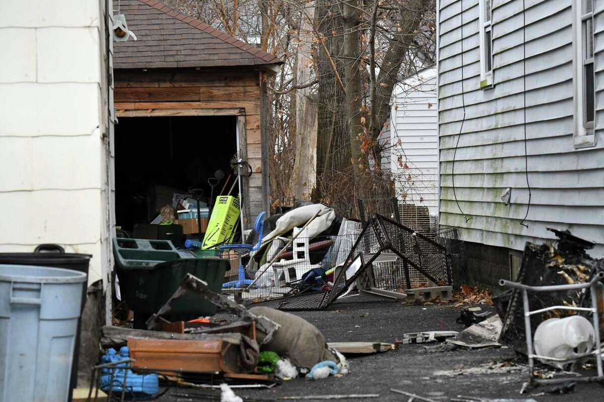 Debris is strewn across the driveway at a 433 Arthur St. home where firefighters rescued a man who allegedly threatened to set fire to the house and open fire on authorities on Thursday, Dec. 8, 2022, in Schenectady, N.Y.