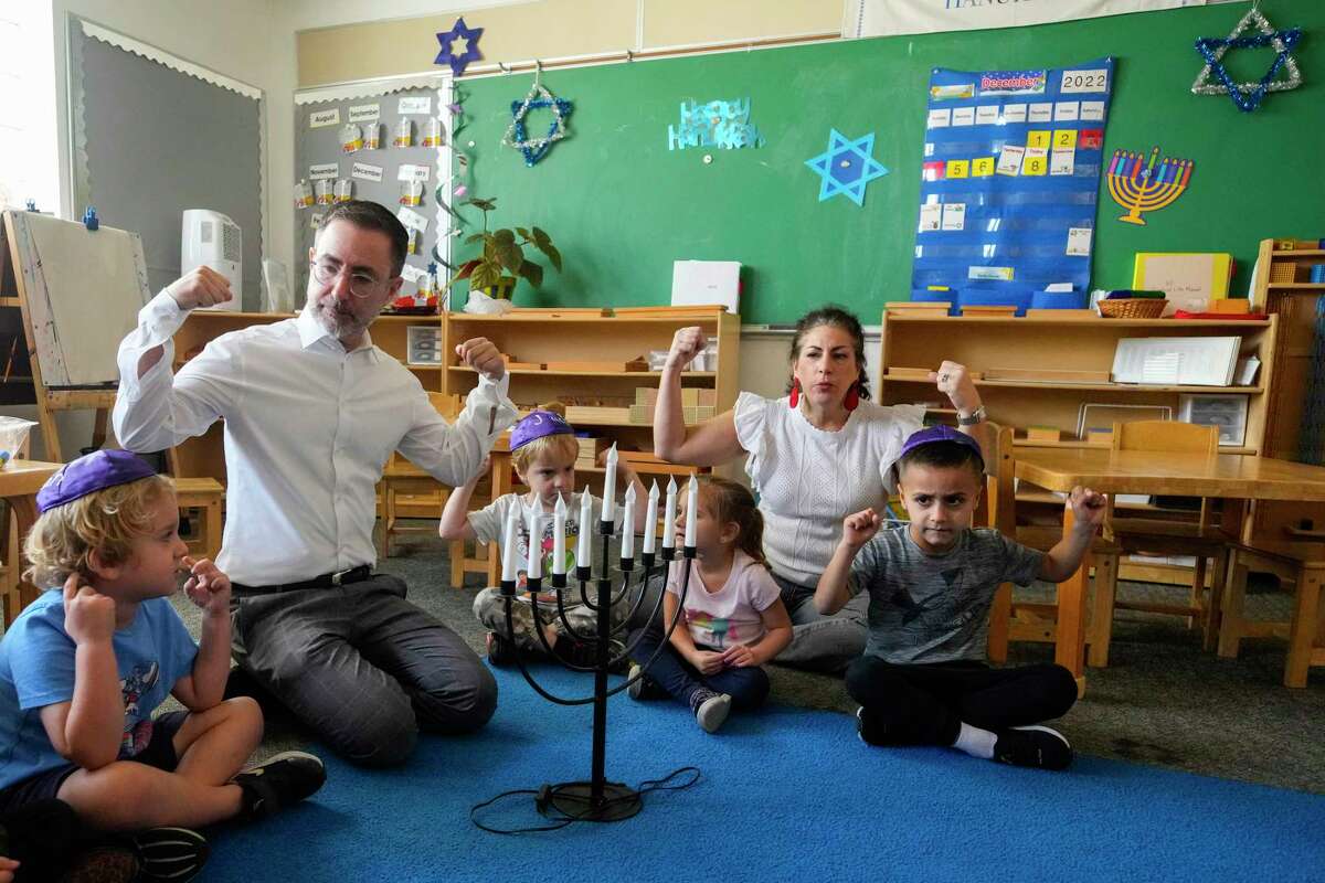 Rabbi Ranon Teller gives a lesson on Hanukkah to a class of 3-6-year-old children at Goldberg Montessori School on Thursday, Dec. 8, 2022 in Houston. Congregation Brith Shalom shares the campus with the school.