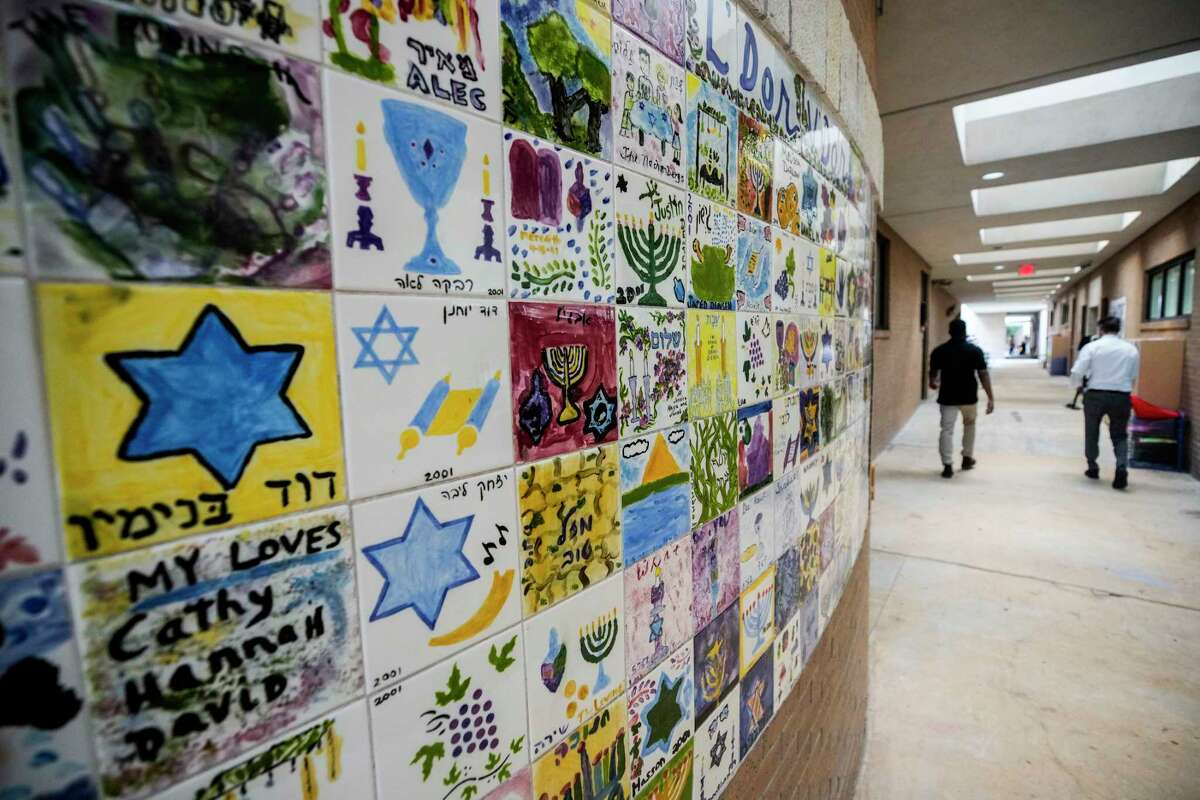 Various tiles featuring symbols of Judaism adorn the walls in a hallway at Goldberg Montessori School on Thursday, Dec. 8, 2022 in Houston. Congregation Brith Shalom shares the campus with the school.