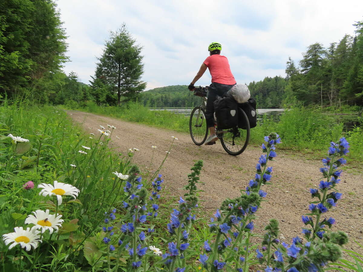 Panniers help travelers on long-distance bike trips, like this one on the Petit Train du Nord in Quebec, lug more gear.