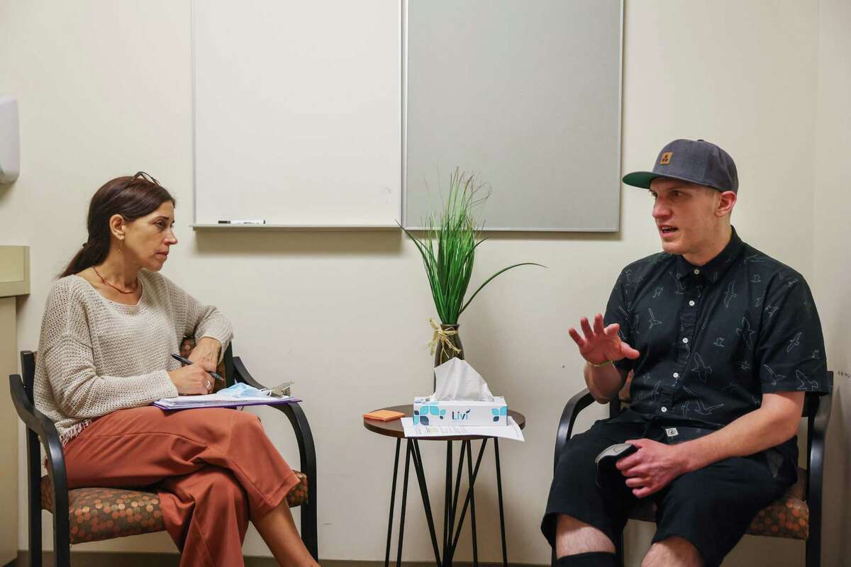 Ben Campofreda, a recovering fentanyl addict, (right) meets with his therapist to discuss his progress in San Francisco, Calif., on Friday, Oct. 7, 2022. He is recovering from multiple surgeries while getting drug treatment.