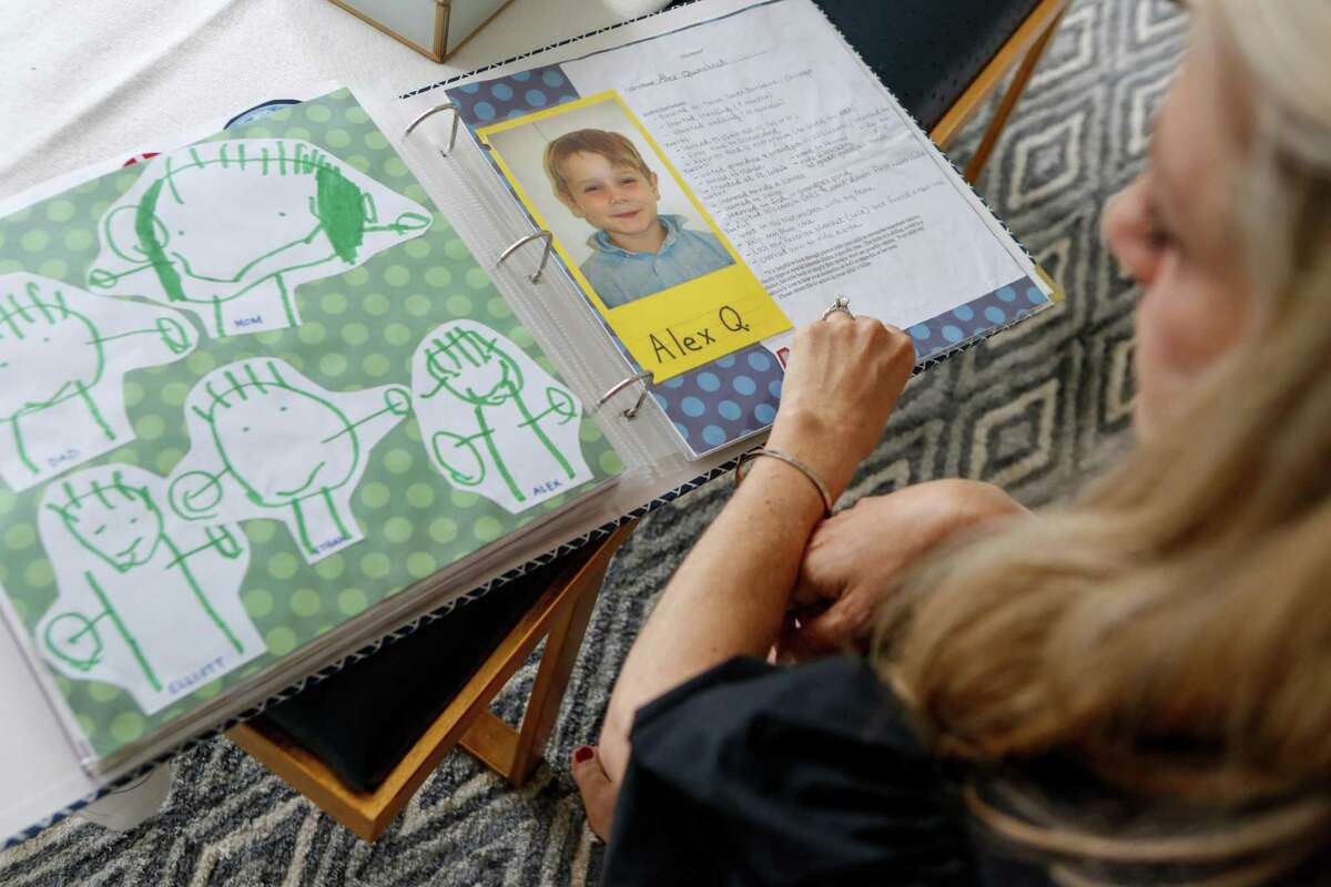 Dayna Quanbeck goes through a photo album of her son Alex in their home on Friday, June 4, 2021 in San Francisco, Calif.