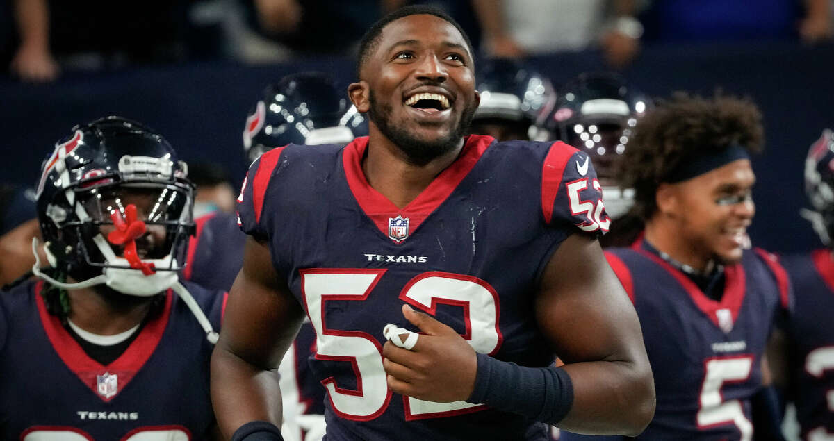 Houston Texans defensive end Jonathan Greenard (52) smiles after an interception by linebacker Jake Hansen (49) during the fourth quarter of an NFL game Thursday, Aug. 25, 2022, in Houston.
