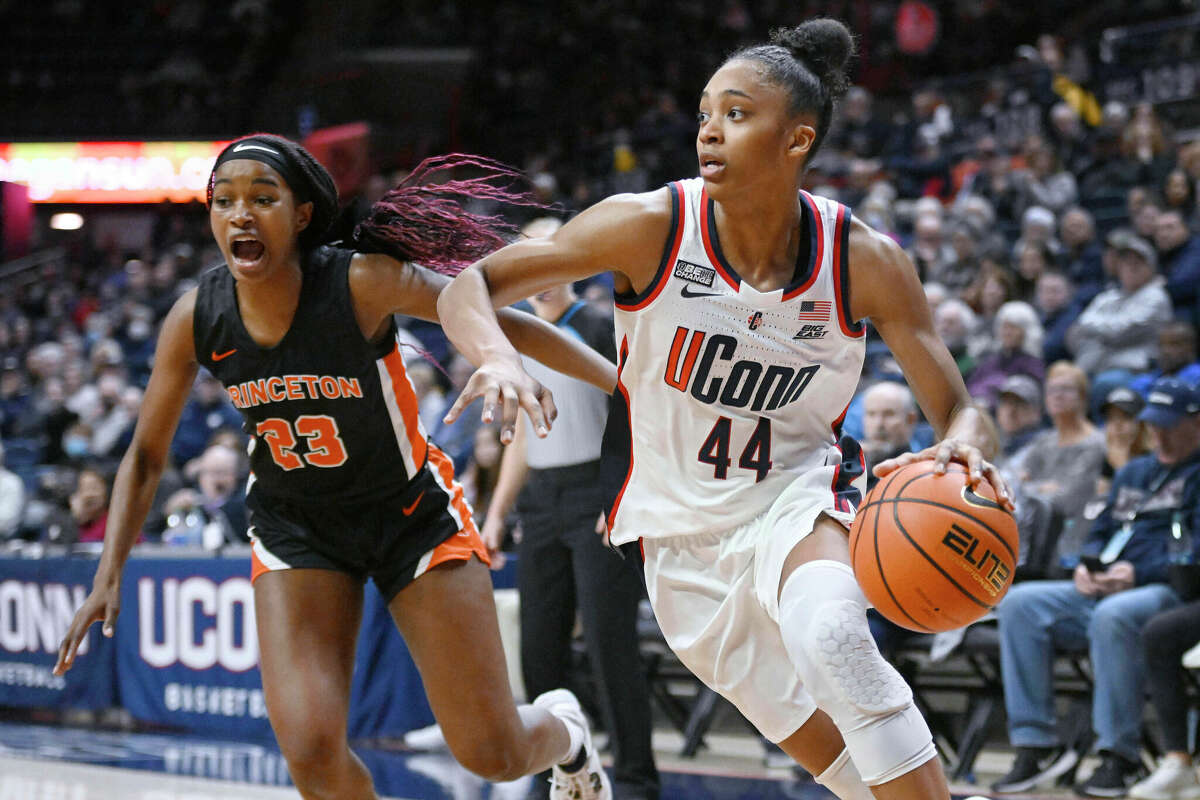UConn's Aubrey Griffin (44) drives to the basket as Princeton's Madison St. Rose (23) defends during the second half of an NCAA college basketball game Thursday, Dec. 8, 2022, in Storrs, Conn. (AP Photo/Jessica Hill)