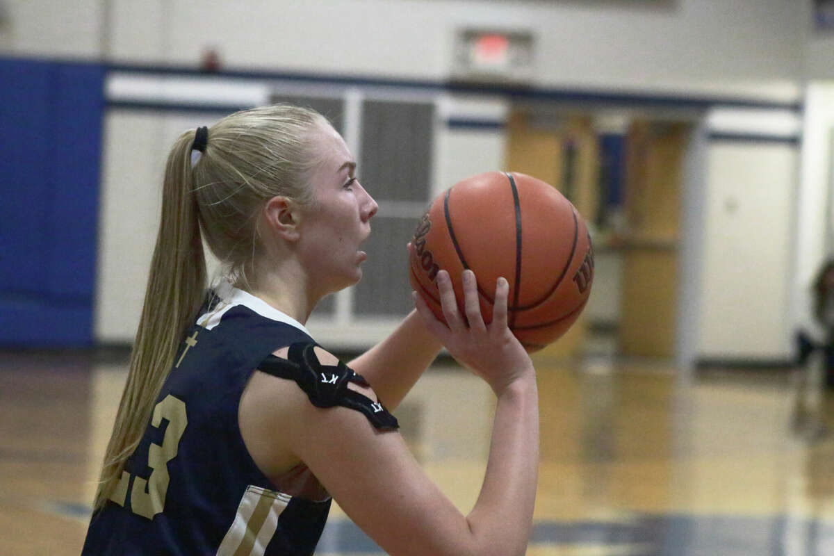 Father McGivney's Sami Oller shoots a three-pointer against Marquette Catholic on Thursday. Oller led all scorers with 20 points in the Griffins 59-35 win. 