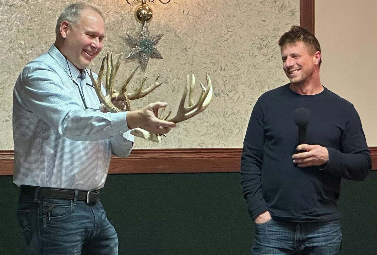 Hunters and outdoor enthusiasts gathered at the Franklin Inn and Banquet Center in Bad Axe on Thursday evening for the annual Greater Thumb Area Hunting Dinner, sponsored by Randy's Hunting Center. Above, master of ceremonies Randy Brown holds up a prize-winning 24-point rack.