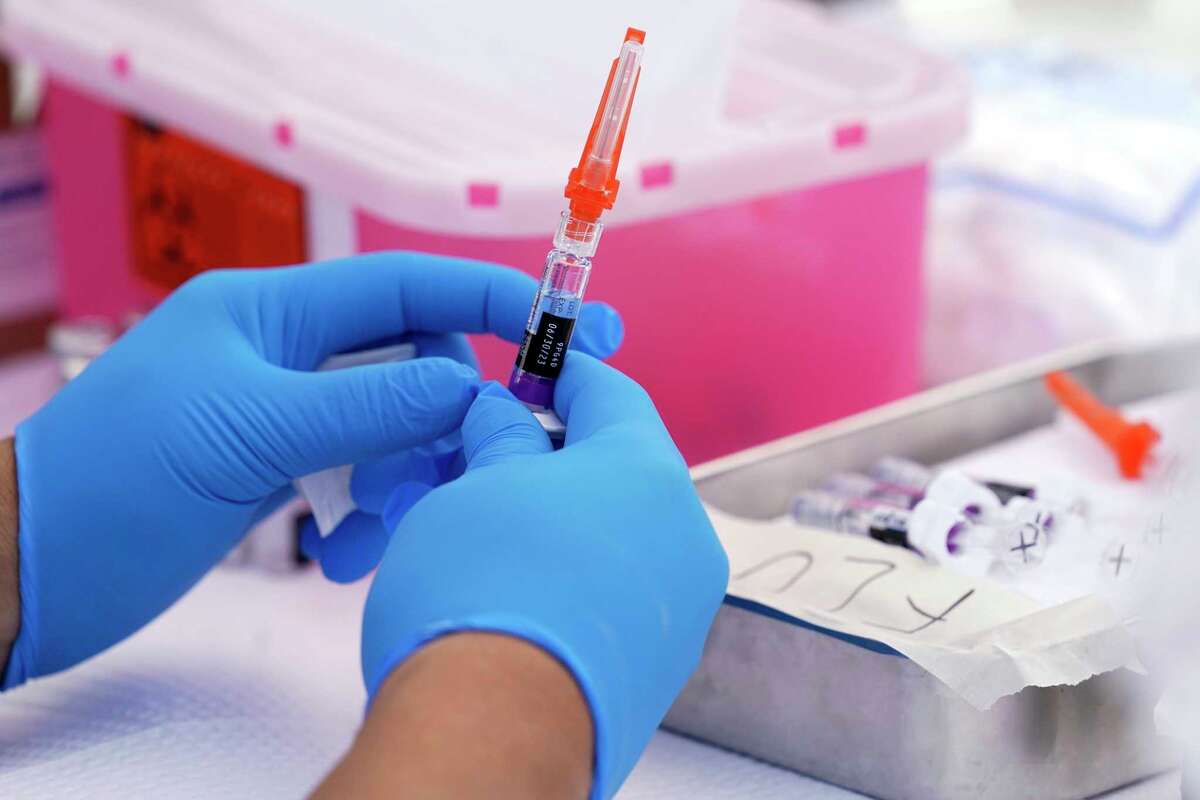 In this file picture, an influenza vaccine is prepared at the L.A. Care Plan and Blue Shield of California Promise Health Plan's Community Resource Center, where they were providing members and the general public complimentary influenza and COVID-19 vaccines Friday, Oct. 28, 2022, in Lynwood, Calif.