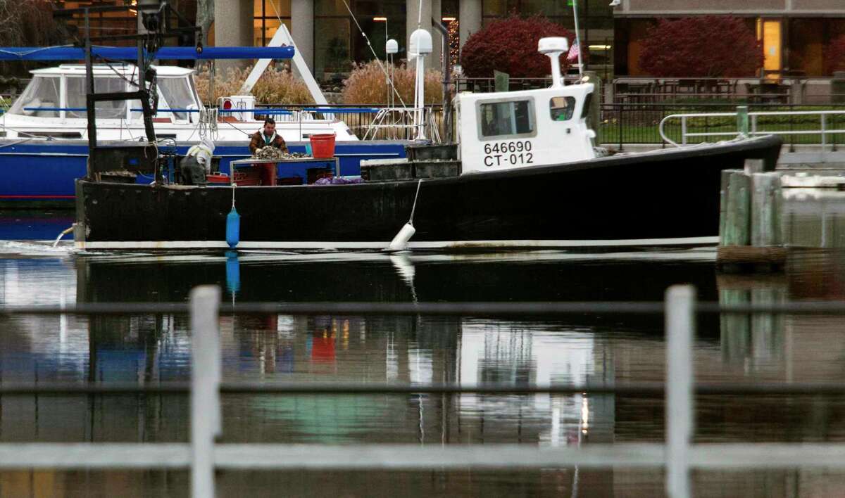 An oyster boat arrives back in port at Czecik Marina in Stamford, Conn.