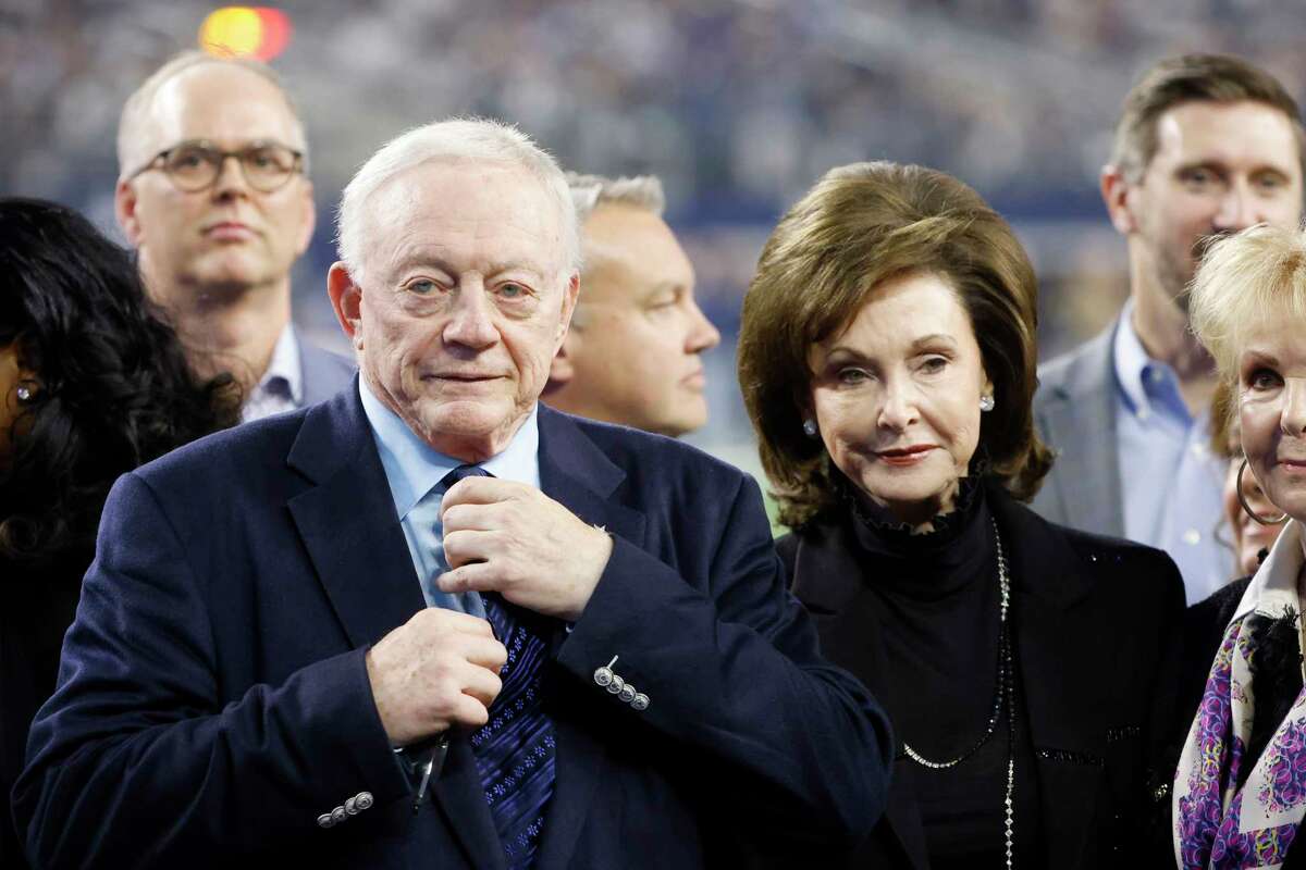 Dallas Cowboys owner Jerry Jones and his wife Gene Jones, right, on the field during an NFL Football game in Arlington, Texas, Sunday, Dec. 4, 2022.