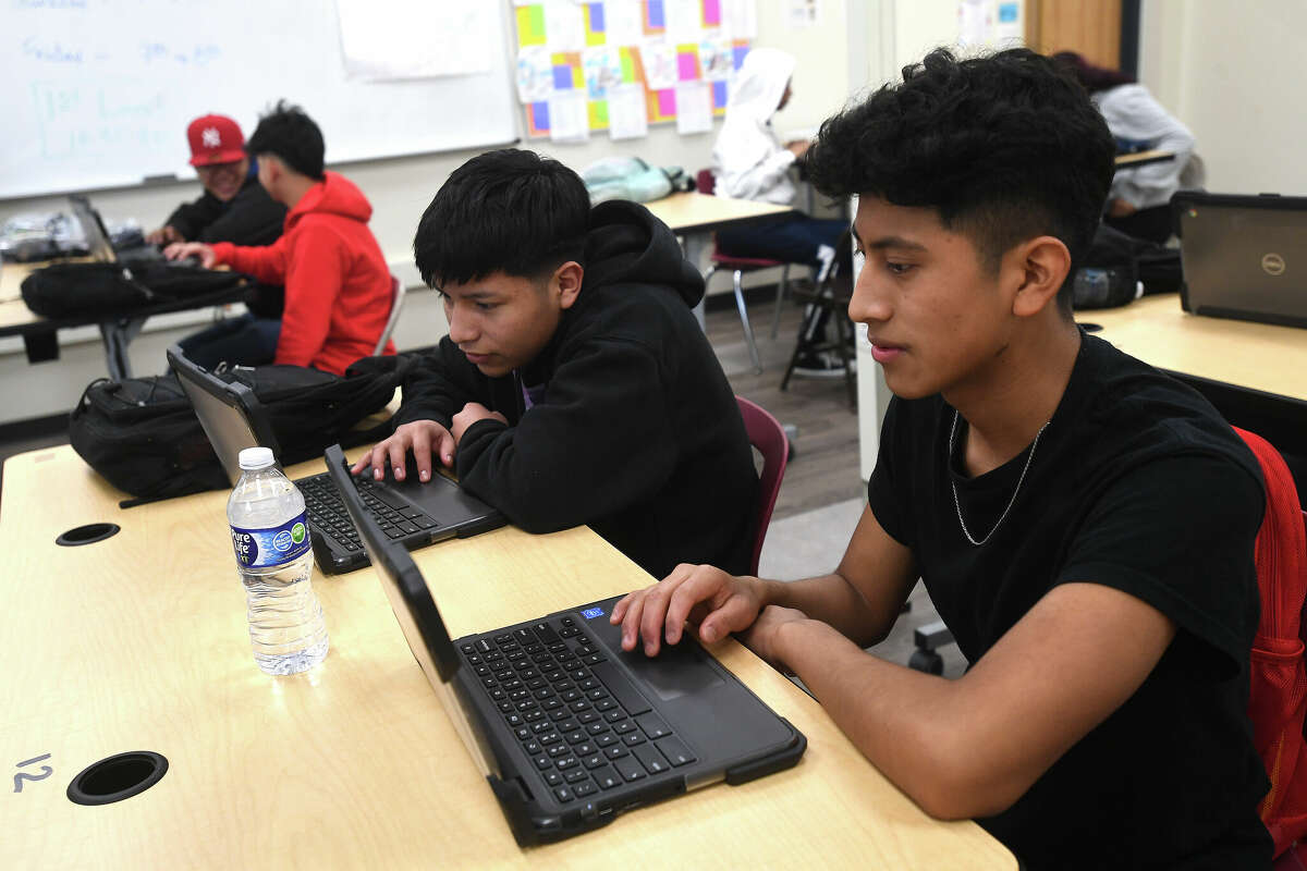 Students in Arturo Rodriguez's math class in Beaumont United's Newcomer Center work on their tablets. Photo made Monday, December 5, 2022 Kim Brent/Beaumont Enterprise