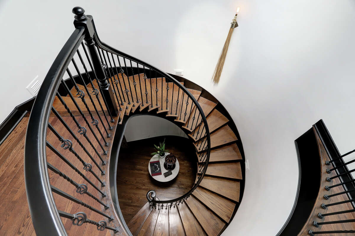 The circular staircase is a dramatic architectural detail.