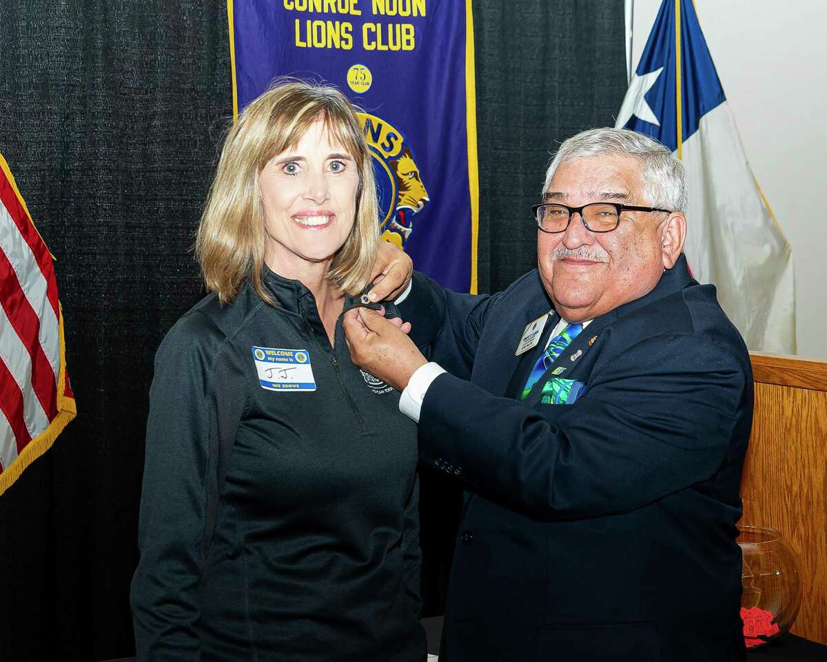 It’s official! The newest member of the Conroe Noon Lions Club, JJ Kuykendall (left) receives her Lions emblem from visiting Lions Clubs International Director TJ Tijerina (right) at the club meeting, bringing their membership to #326 the largest in the state of Texas.