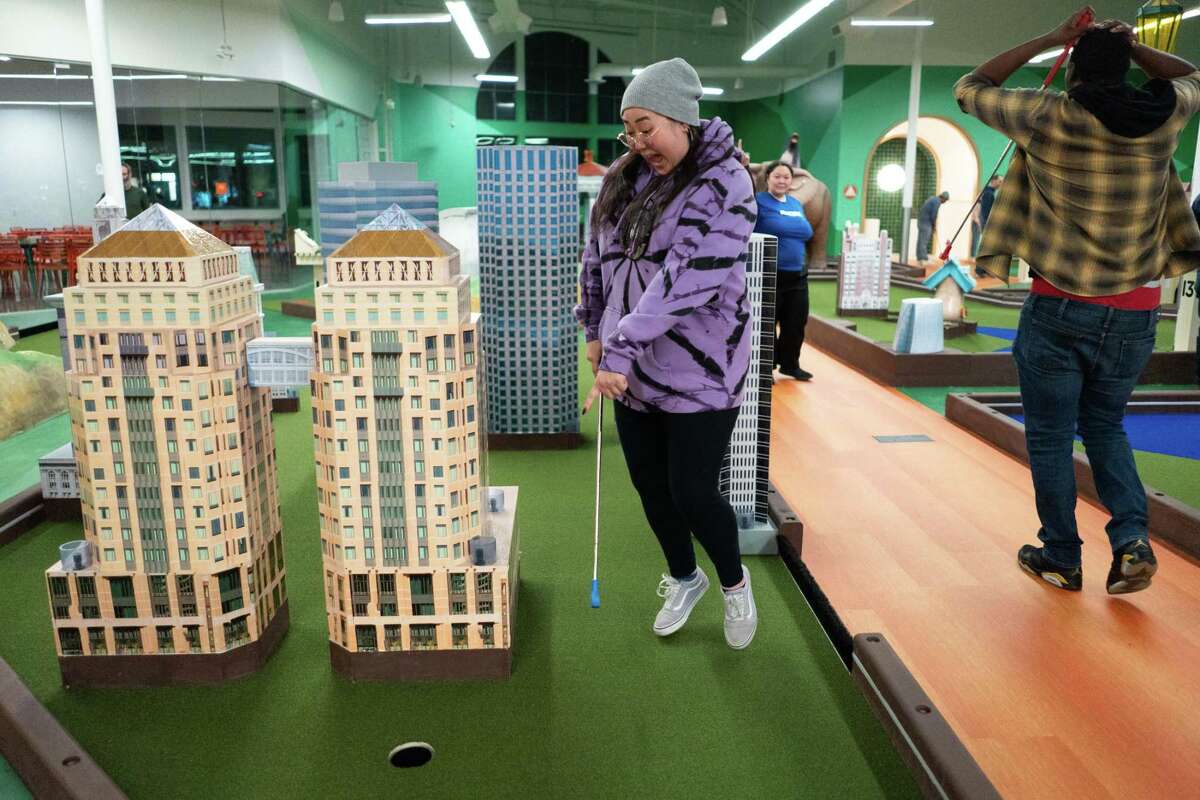 Cathy Chao reacts after realizing she hit a hole-in-one through the downtown Oakland hole 14 at Subpar Miniature Golf in Alameda on Dec. 8. She finished the course with a total of two hole-in-one shots.