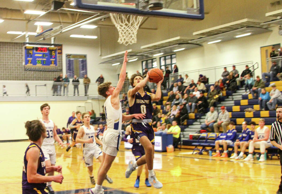 Onekama sophomore Caden Bradford (middle in white) attempts to block a layup attempt against Frankfort on Dec. 9, 2022 at Onekama Consolidated Schools.