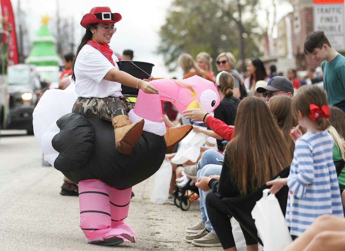 Regina Isidro hands out candy during the annual Montgomery Christmas Parade, Saturday, Dec. 10, 2022, in Montgomery.