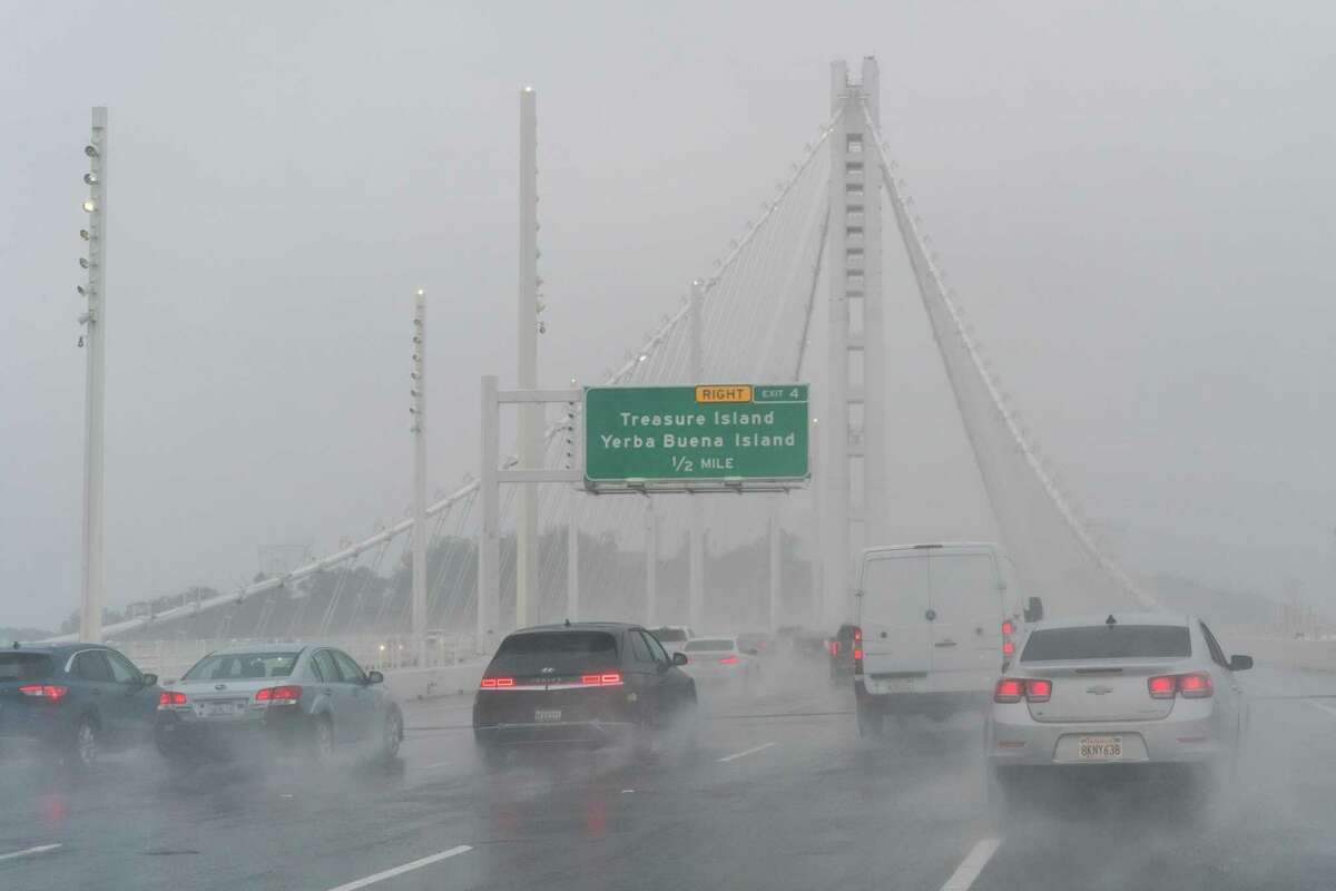 Vehicles drive through heavy rain and fog on the San Francisco-Oakland Bay Bridge, Saturday, Dec. 10, 2022.