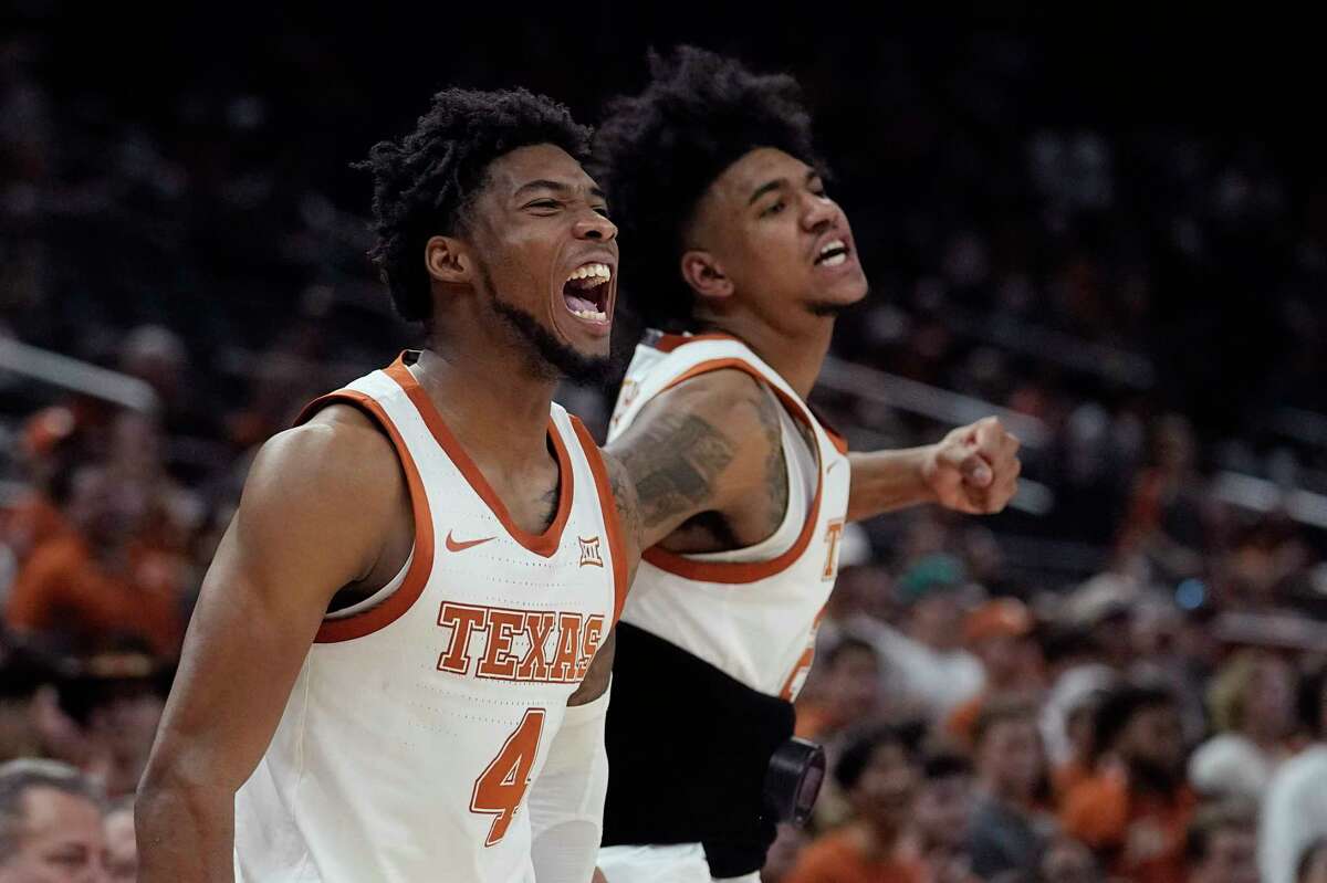 Texas guard Tyrese Hunter (4) and Texas forward Dillon Mitchell, right, celebrate a score during the second half of an NCAA college basketball game against Arkansas-Pine Bluff in Austin, Texas, Saturday, Dec. 10, 2022. (AP Photo/Eric Gay)