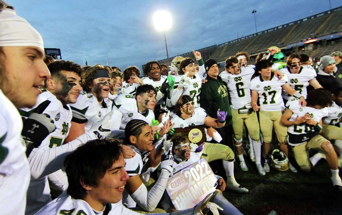 Notre Dame of West Haven poses with the championship plaque after beating Berlin in CIAC Class M state championship football action at Rentschler Field in East Hartford, Conn., on Saturday December 10, 2022.
