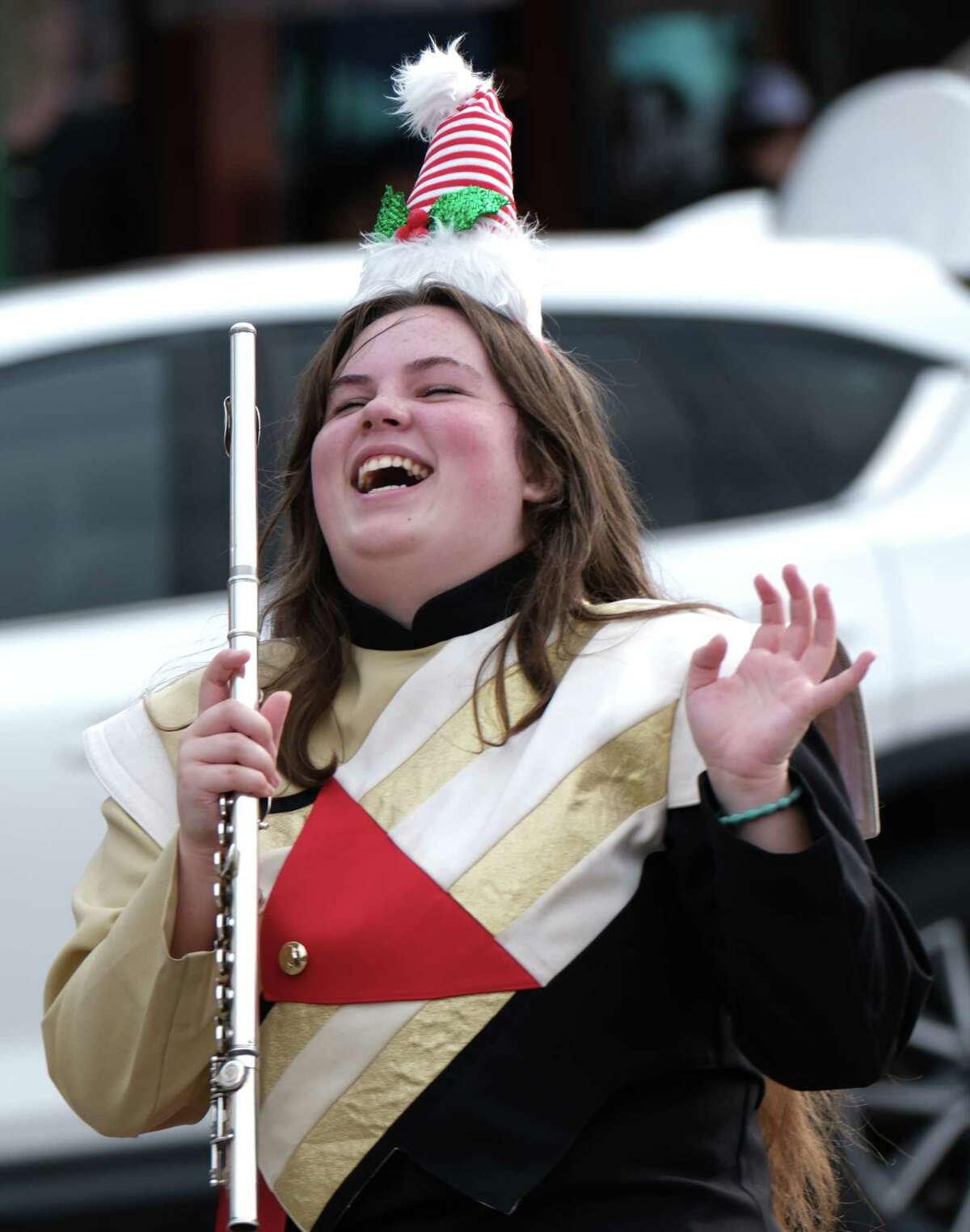 During the Annual Toby Powell Conroe Christmas Parade, a Caney Creek High School Band flautist is all smiles. 