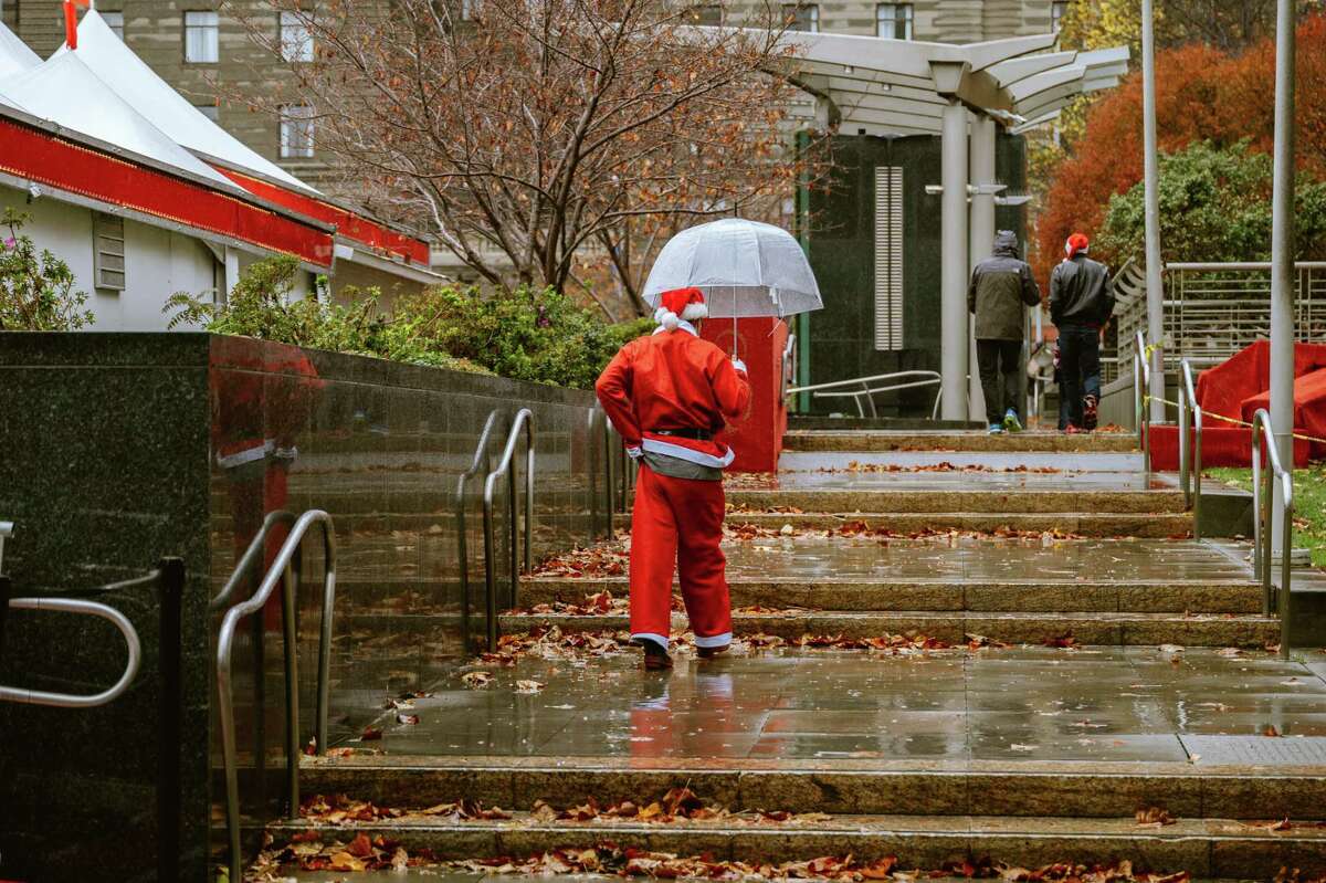 Rain failed to dampen the spirits of SantaCon participants in San Francisco’s Union Square.