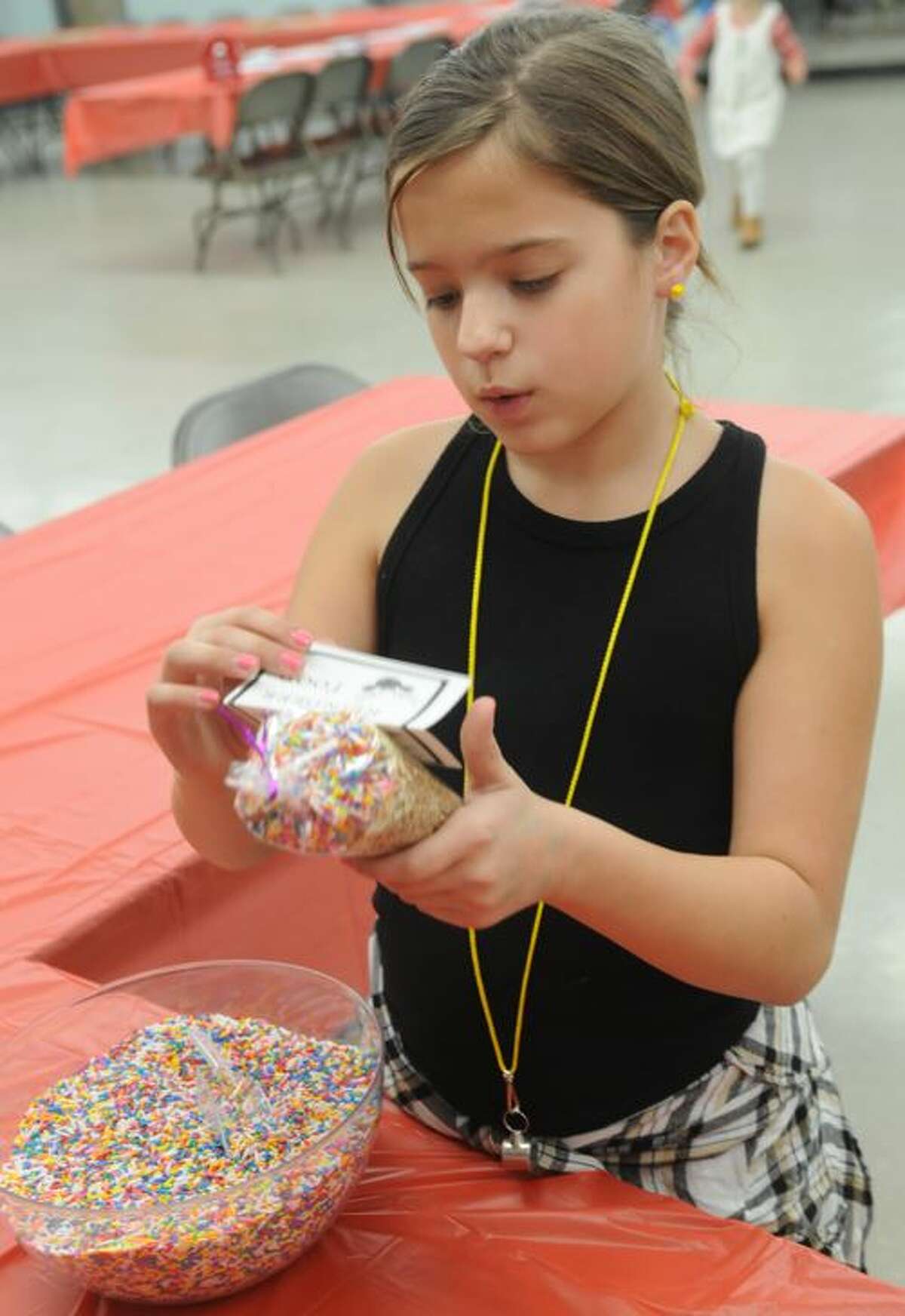 Reagan Guswelle of Edwardsville examines the container of reindeer food she created during Saturday's Epic Santa Day event in Worden.