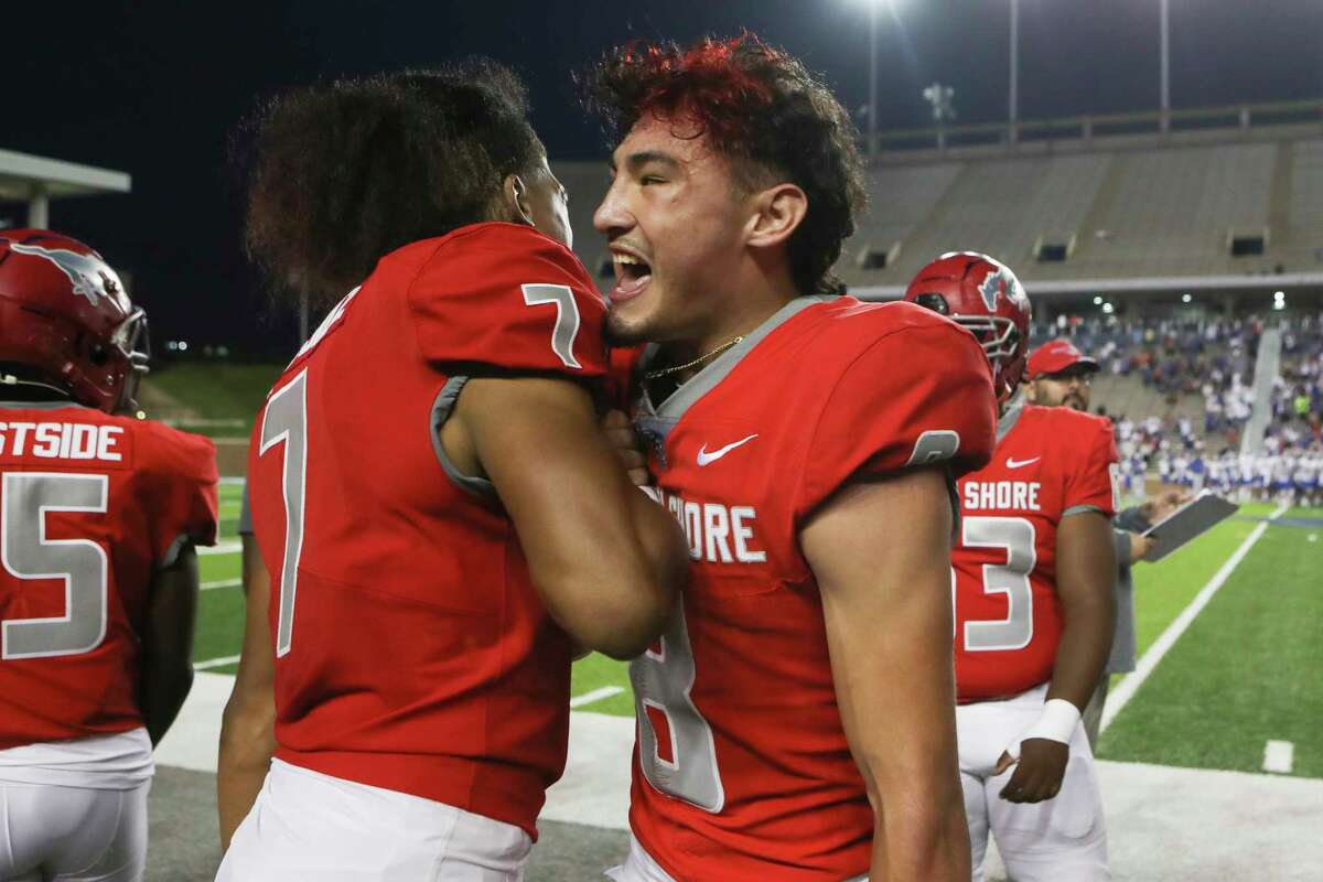 North Shore quarterback David Amador (8) celebrates with defensive back Jayven Anderson (7) in the losing moments of the fourth quarter of a high school Class 6A Division I state semifinal football game at Rice Stadium, Saturday, Dec. 10, 2022, in Houston.