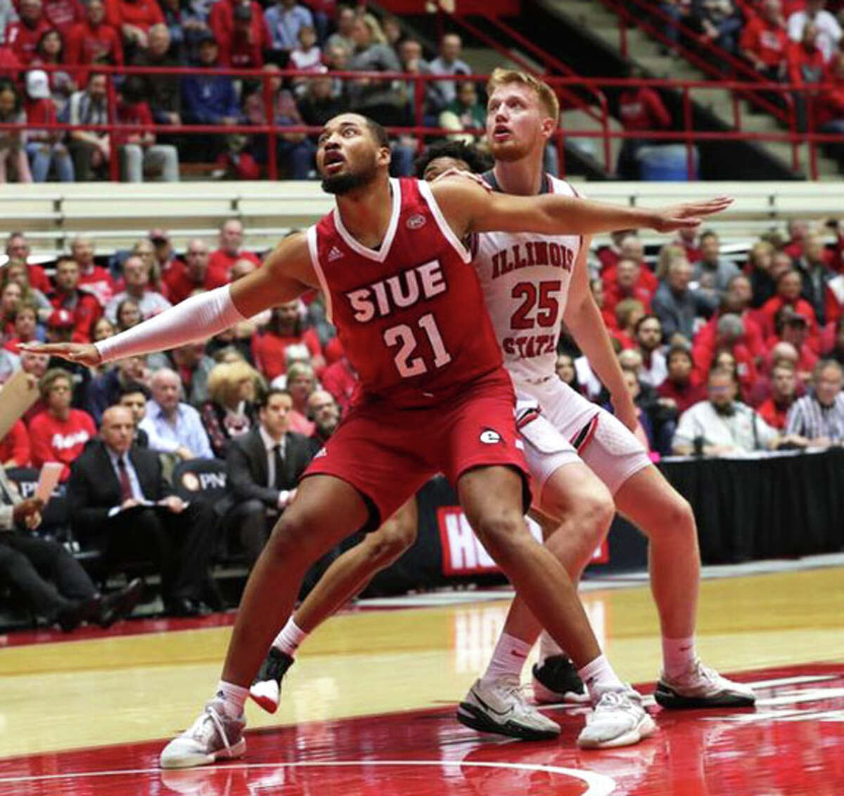 SIUE Terrance Thompson (21) seals off Illinois State's Alex Kotov looking for a rebound Saturday at Horton Fieldhouse in Normal.