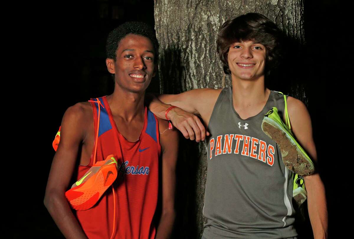 Cross Crunners runners Jefferson’s Henok Hayele and TMI’s Franco Parra on Wednesday, Dec. 7, 2022 at TMI-Episcopal gym.