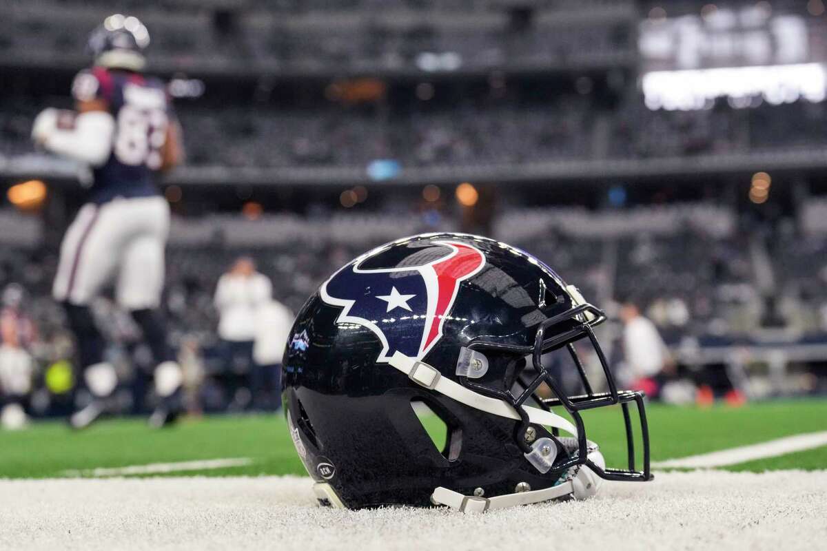 A Houston Texans helmet sits on the field before an NFL football game against the Dallas Cowboys Sunday, Dec. 11, 2022, in Arlington.