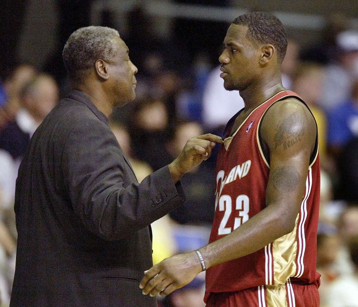 Cleveland Cavaliers' head coach Paul Silas, left, talks with LeBron James, right, during their game against the Atlanta Hawks in Asheville, N.C., Wednesday, Oct. 8, 2003. (AP Photo/Chuck Burton) HOUCHRON CAPTION (10/09/2003 - 2-STAR): Cavs coach Paul Silas talks to LeBron James during Wednesday's game with Atlanta.