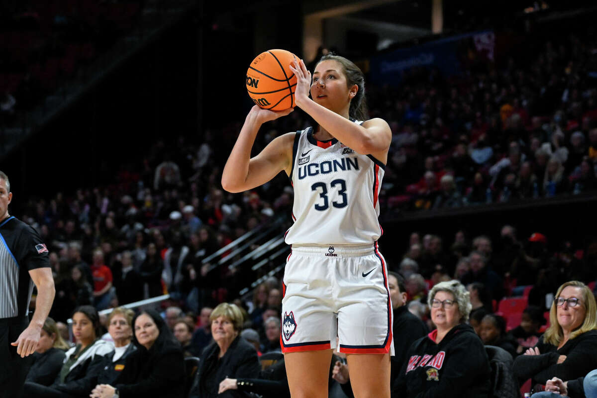 Connecticut guard Caroline Ducharme (33) shoots the ball during the first half of an NCAA college basketball game against Maryland, Sunday, Dec. 11, 2022, in College Park, Md. (AP Photo/Terrance Williams)