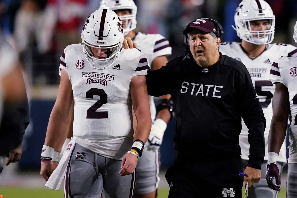 Mississippi State coach Mike Leach confers with quarterback Will Rogers (2) during the first half of the team's NCAA college football game against Mississippi in Oxford, Miss., Thursday, Nov. 24, 2022.