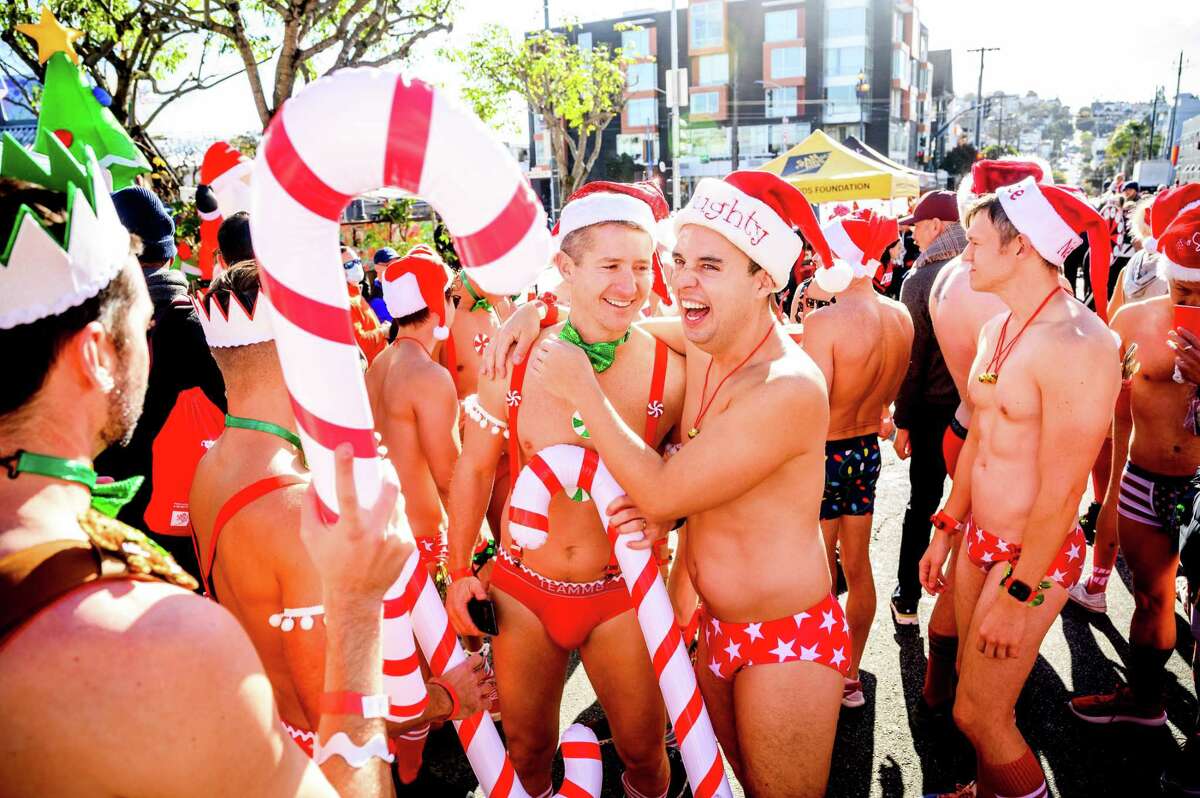 Richard Parenteau hugs Brien Bell during Santa Skivvies, a 1-mile run through San Francisco’s Castro district. The event, in its 14th consecutive year, raises money for the San Francisco AIDS Foundation.