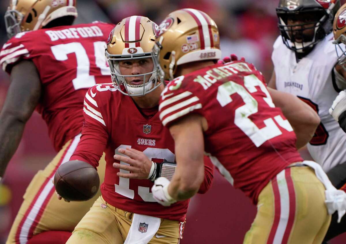 SANTA CLARA, CALIFORNIA - DECEMBER 11: Brock Purdy #13 of the San Francisco 49ers hands the ball off to Christian McCaffrey #23 during the second quarter of the game against the Tampa Bay Buccaneers at Levi's Stadium on December 11, 2022 in Santa Clara, California.
