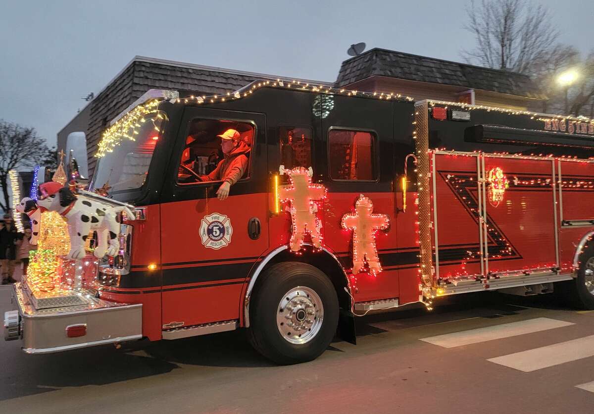 A fire engine from the Benzonia Fire Department decorated with lights rolls through downtown Beulah for the Christmas Magic parade.  