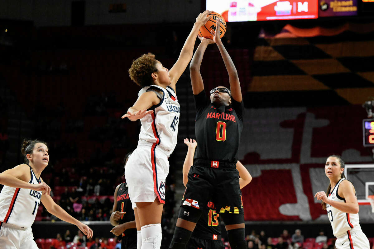 Maryland guard Shyanne Sellers (0) has her shot blocked by Connecticut forward Amari DeBerry (42) during the second half of an NCAA college basketball game, Sunday, Dec. 11, 2022, in College Park, Md. (AP Photo/Terrance Williams)