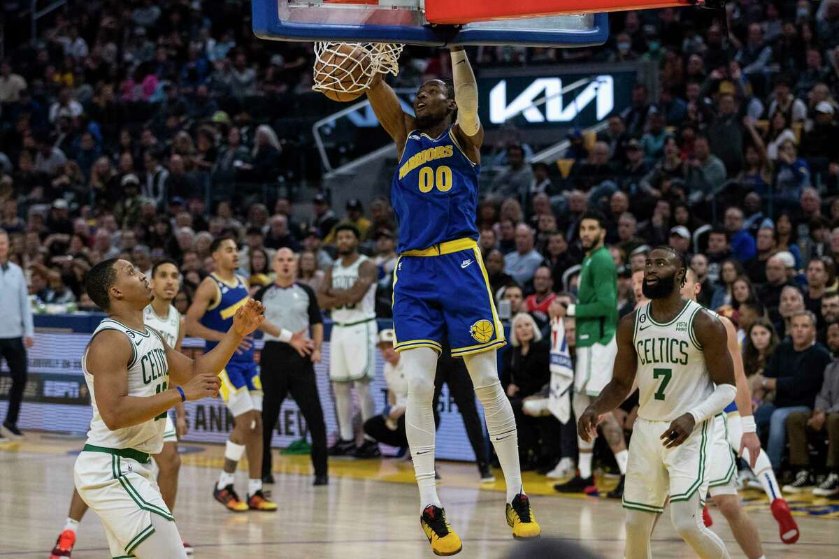 Golden State Warriors forward Jonathan Kuminga (00) makes a dunk during the fourth quarter of a NBA basketball game against Boston Celtics in San Francisco, Calif. Saturday, Dec. 10, 2022. The Warriors defeated the Celtics 123-107.
