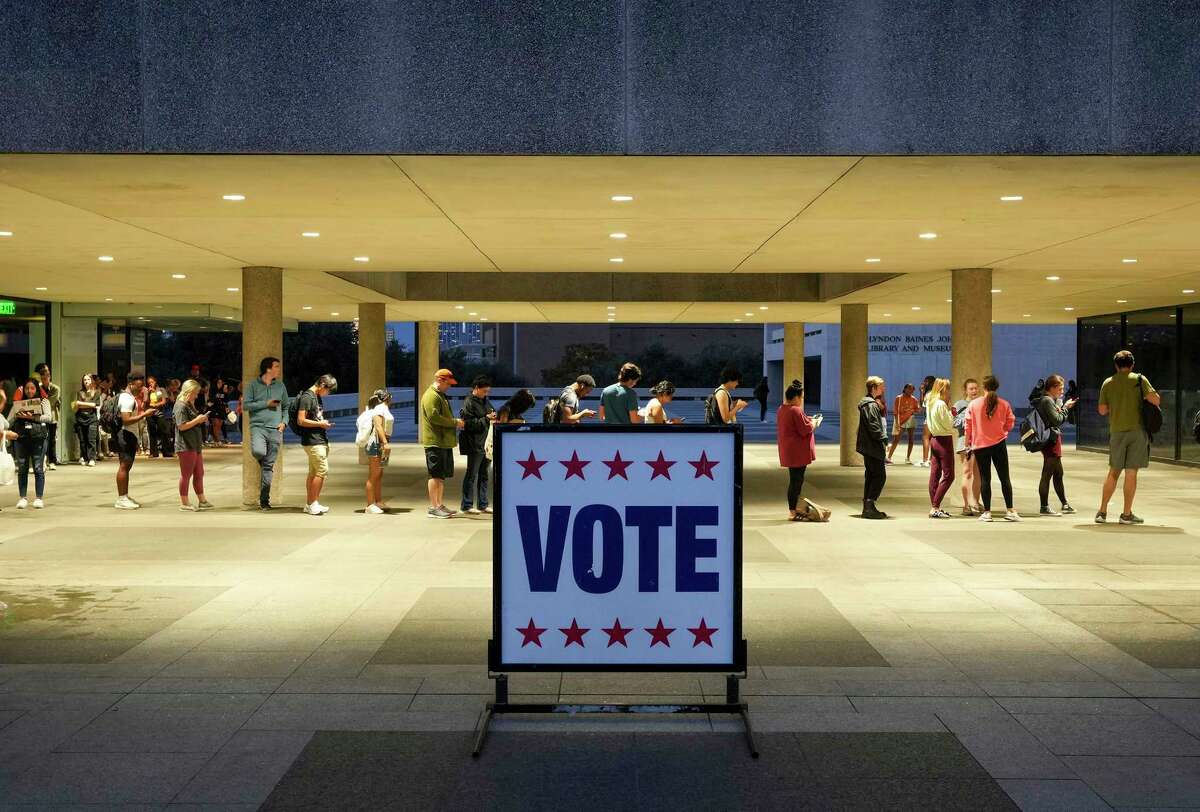 FILE - Voters wait in line at a polling place at the Lyndon B. Johnson School of Public Affairs in Austin, Texas, on election night Nov. 8, 2022. Midterm voters under 30 went 53% for Democrats compared to 41% for Republicans nationwide. That was down from such voters supporting President Joe Biden over his predecessor, Donald Trump, by a 61% to 36% in 2020, according to AP VoteCast, a sweeping national survey of voters in November’s election. (Jay Janner/Austin American-Statesman via AP, File)