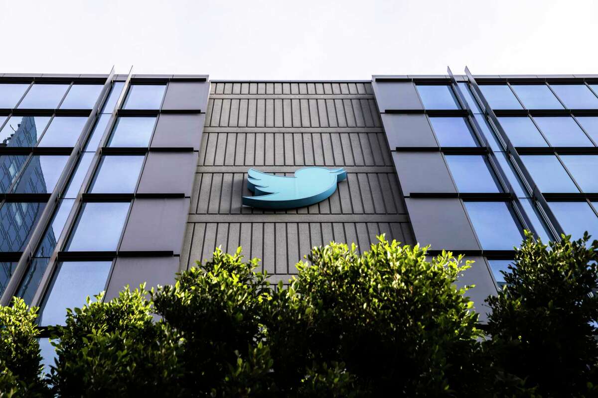 The Twitter logo is seen at Twitter headquarters in San Francisco, Calif. The company began auctioning off surplus office furniture and memorabilia.