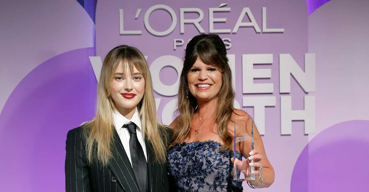 Actress Katherine Langford, left, announced that Texan Susie Vybrial had been named the national honoree as part of L'Oreal Paris' Women of Worth competition. 