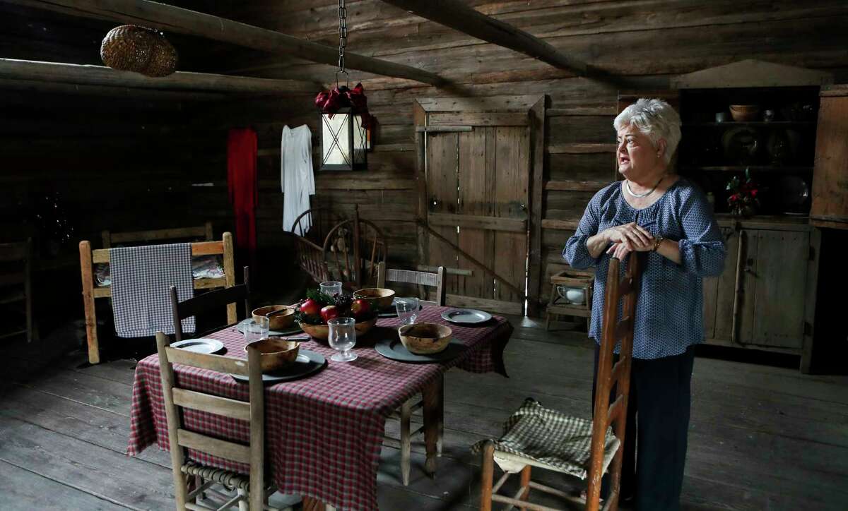 Montgomery resident Eva Rains talks about her family’s restored 1900-era painting of her relative, Mary Ann Havard Crain, and her husband, Nicholas Crain, in the cabin her family built, Tuesday, Dec. 6, 2022, in Montgomery. The portrait of the Cranes, along with the cabin, built in 1867, are displayed in Montgomery's Fernland Historical Park.