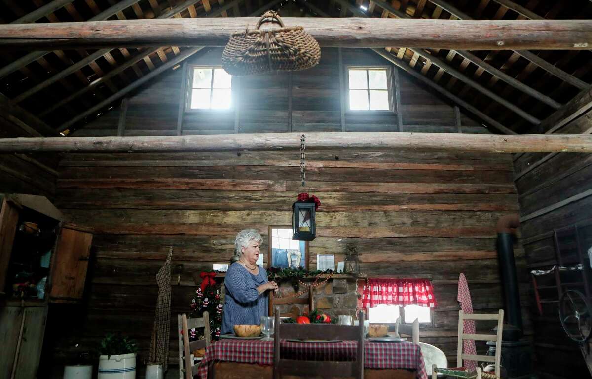 Montgomery resident Eva Rains talks about her family’s restored 1900-era painting of her relative, Mary Ann Havard Crain, and her husband, Nicholas Crain, in the cabin her family built, Tuesday, Dec. 6, 2022, in Montgomery. The portrait of the Cranes, along with the cabin, built in 1867, are displayed in Montgomery's Fernland Historical Park.